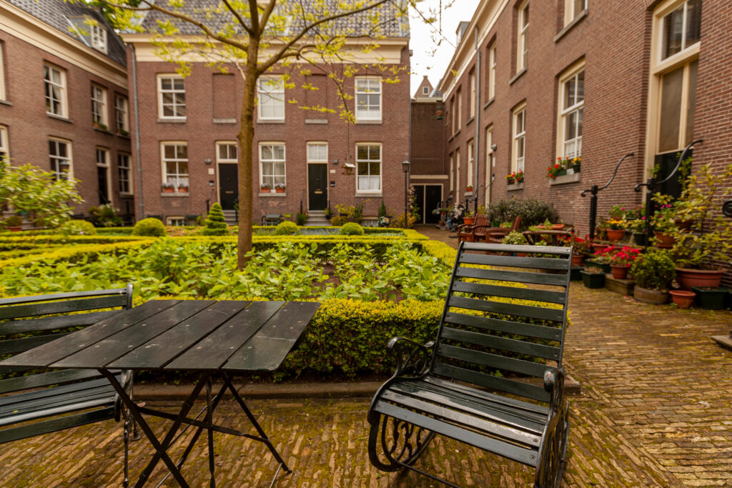 Senior living facility courtyard with greenery and furniture.
